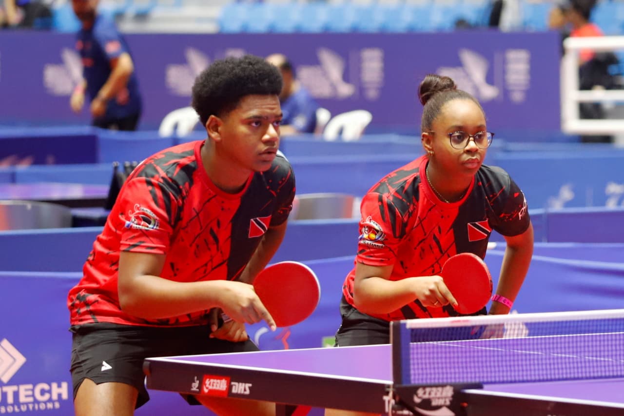 Trinidad and Tobago junior players in doubles ready position at an international table tennis tournament