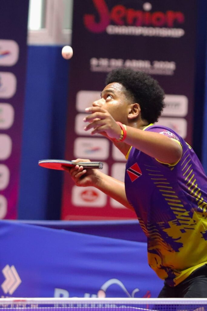 Table tennis player in a focused pre-serve routine during competition